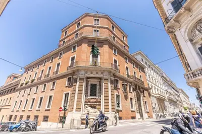 a large brick building on the corner of a street at XX SETT: Flat by Barberini Trevi Fountain in Rome