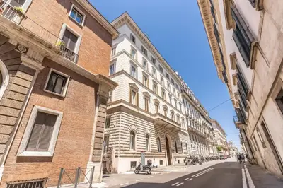 a large brick building on the side of a street at XX SETT: Flat by Barberini Trevi Fountain in Rome