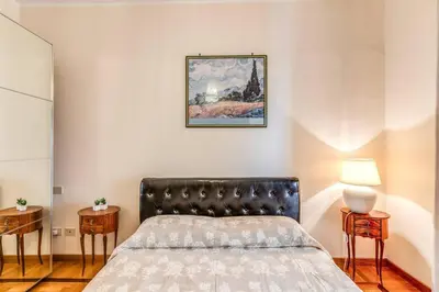 a bedroom with a bed and two side tables at XX SETT: Flat by Barberini Trevi Fountain in Rome