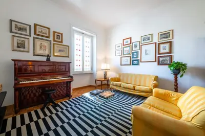 a living room with a piano and a couch at Casa Emme in Rome