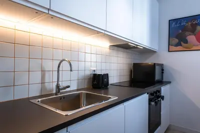 a kitchen with a sink and a microwave at Casa Emme in Rome