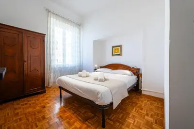 a bedroom with a bed and a wooden floor at Casa Emme in Rome
