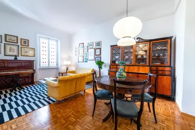 a living room with a table and a piano at Casa Emme in Rome