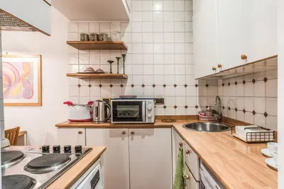 a kitchen with a sink and a microwave at Cozy flat in Trevi Fountain in Rome