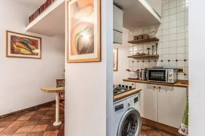 a kitchen with a washer and dryer in a room at Cozy flat in Trevi Fountain in Rome