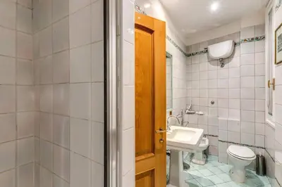 a bathroom with a toilet and a sink at Cozy flat in Trevi Fountain in Rome