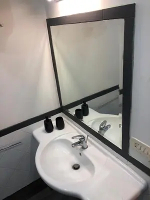 a bathroom with a sink and a mirror at ALMA Rooms Appia in Rome