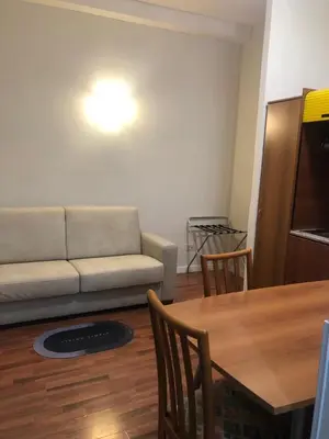 a living room with a couch and a table at ALMA Rooms Appia in Rome