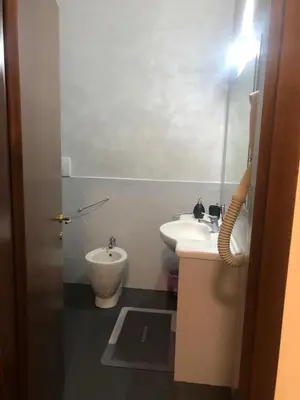 a small bathroom with a sink and a toilet at ALMA Rooms Appia in Rome