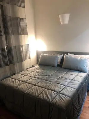 a bed with two pillows in a room at ALMA Rooms Appia in Rome