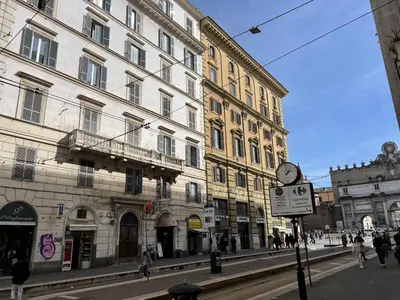 a city street with buildings and a clock on a pole at Maresi Suite in Rome