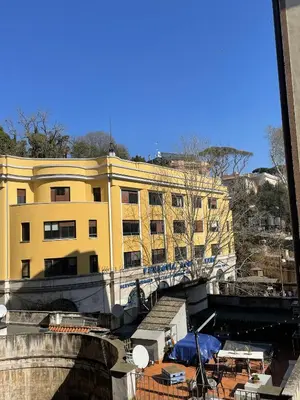 a yellow building with a bridge in front of it at Maresi Suite in Rome