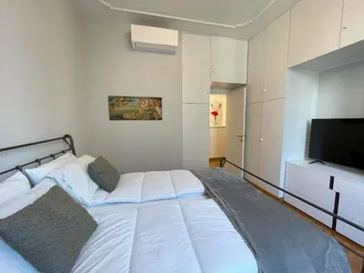 a bedroom with a bed and a flat screen tv at Maresi Suite in Rome