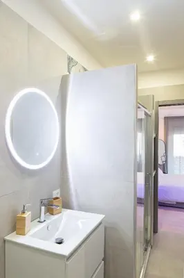 a white bathroom with a sink and a mirror at Maria Romita in Rome