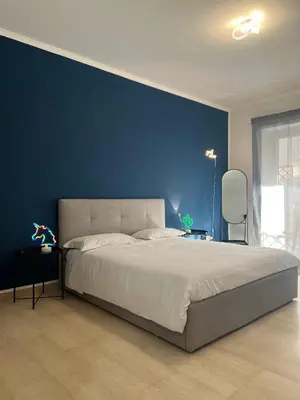 a bedroom with a blue wall and a large bed at Maria Romita in Rome