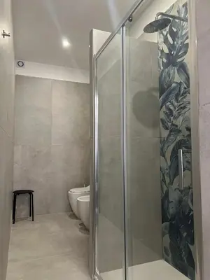 a bathroom with a glass shower with a toilet at Maria Romita in Rome