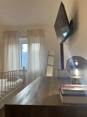 a room with a desk with a television and a bed at Maria Romita in Rome
