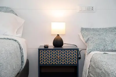 a bedroom with two beds and a lamp on a night stand at St Peter Boutique 1 in Rome