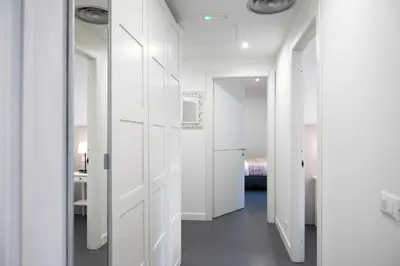 a hallway with white doors and a bedroom at St Peter Boutique 1 in Rome