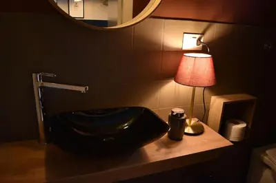 a bathroom with a sink and a lamp on a counter at BOUTIQUE TRASTEVERE in Rome