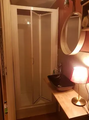 a bathroom with a shower with a sink and a mirror at BOUTIQUE TRASTEVERE in Rome