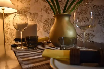 a table with two wine glasses and a vase at BOUTIQUE TRASTEVERE in Rome