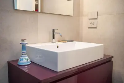 a bathroom with a white sink and a vase on a counter at Sant'Agata in Trastevere in Rome