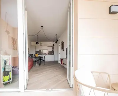 an open door into a living room with a kitchen at Sant'Agata in Trastevere in Rome