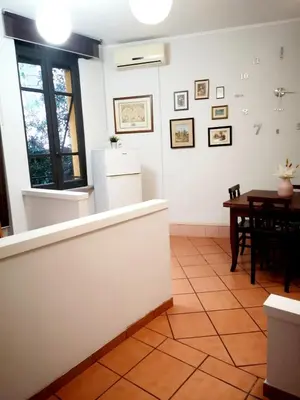 a hallway with white walls and pictures on the wall at Happy House in Piazza Zama in Rome
