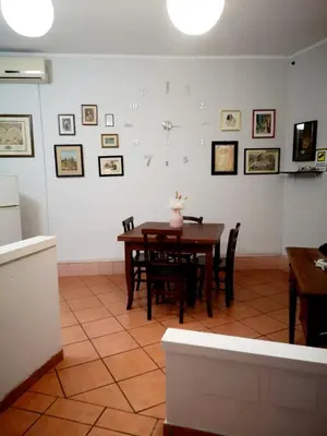 a dining room with a table and chairs at Happy House in Piazza Zama in Rome