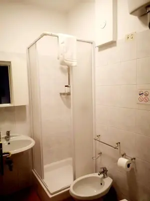 a bathroom with a shower and a toilet and a sink at Happy House in Piazza Zama in Rome