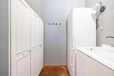 a white bathroom with a sink and a refrigerator at maison pelliccia Terrace in Rome