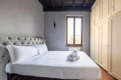 a bedroom with a bed with towels on it at maison pelliccia Terrace in Rome