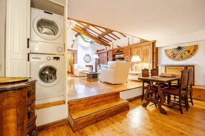 a kitchen and living room with a washer and dryer at Rome's Hidden Gem in Rome