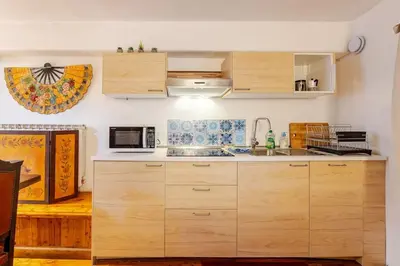 a kitchen with wooden cabinets and a microwave at Rome's Hidden Gem in Rome
