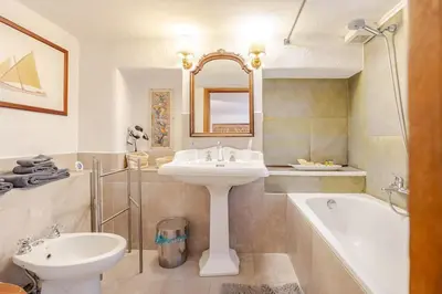 a bathroom with a sink and a toilet and a tub at Rome's Hidden Gem in Rome