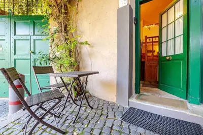 a chair and a table in front of a door at Rome's Hidden Gem in Rome