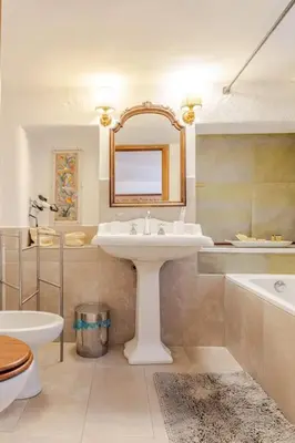 a bathroom with a sink and a tub and a toilet at Rome's Hidden Gem in Rome