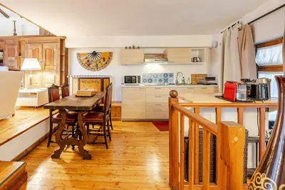 a kitchen with a wooden table and a dining room at Rome's Hidden Gem in Rome