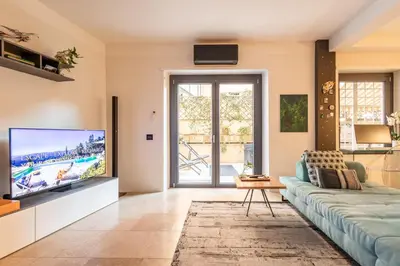 a living room with a couch and a tv at Ædrian's Loft. Boutique apartment with private terrace in the center of Rome in Rome