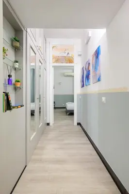a hallway of a home with white walls and wood floors at Appartamento via di Torre Argentina (Navona) in Rome