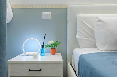 a bedroom with a bed and a mirror on a night stand at Appartamento via di Torre Argentina (Navona) in Rome