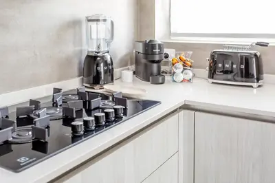 a kitchen counter with a coffee maker on a stove at Gregory 7House Vaticano in Rome