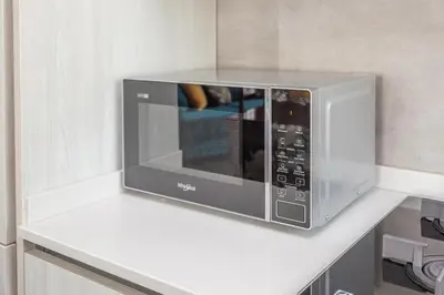 a microwave on a white counter in a kitchen at Gregory 7House Vaticano in Rome