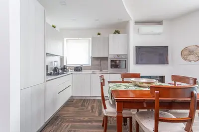 a kitchen with a table and a dining room at Gregory 7House Vaticano in Rome