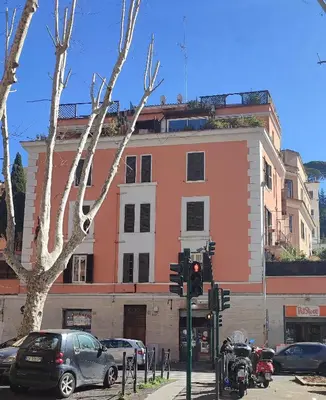 a building on a street with cars and a traffic light at Have a nice stay in Rome 2 in Rome