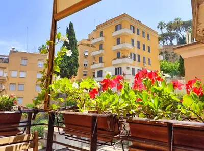 a view of a building from a balcony with flowers at Have a nice stay in Rome 2 in Rome
