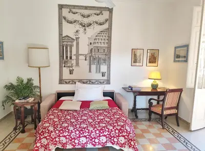 a bedroom with a bed and a table and a picture on the wall at Have a nice stay in Rome 2 in Rome