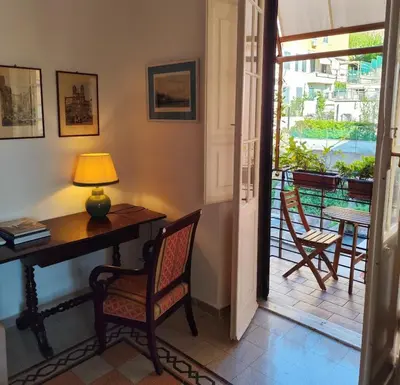 a room with a desk and chairs and a balcony at Have a nice stay in Rome 2 in Rome
