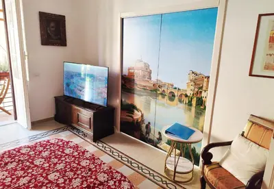 a living room with a tv and a large window at Have a nice stay in Rome 2 in Rome